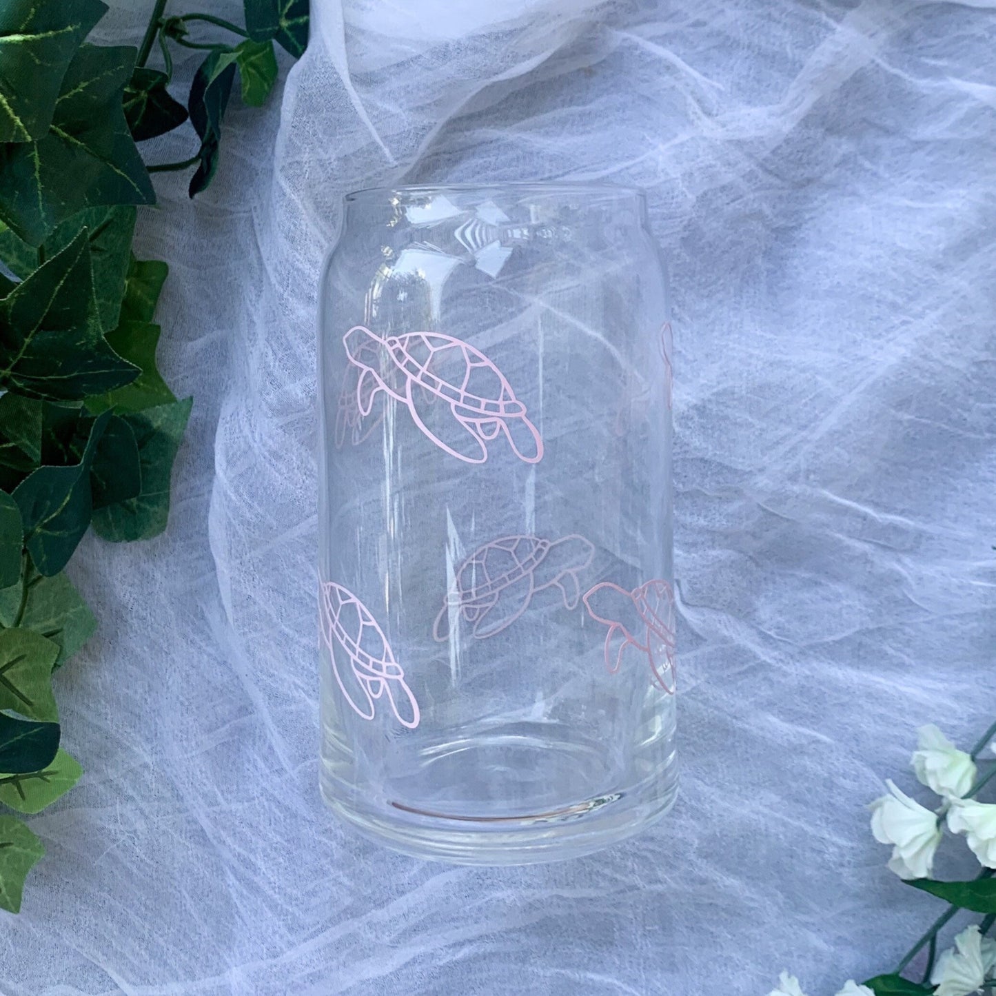 Clear glass with delicate sea turtle line work on it.