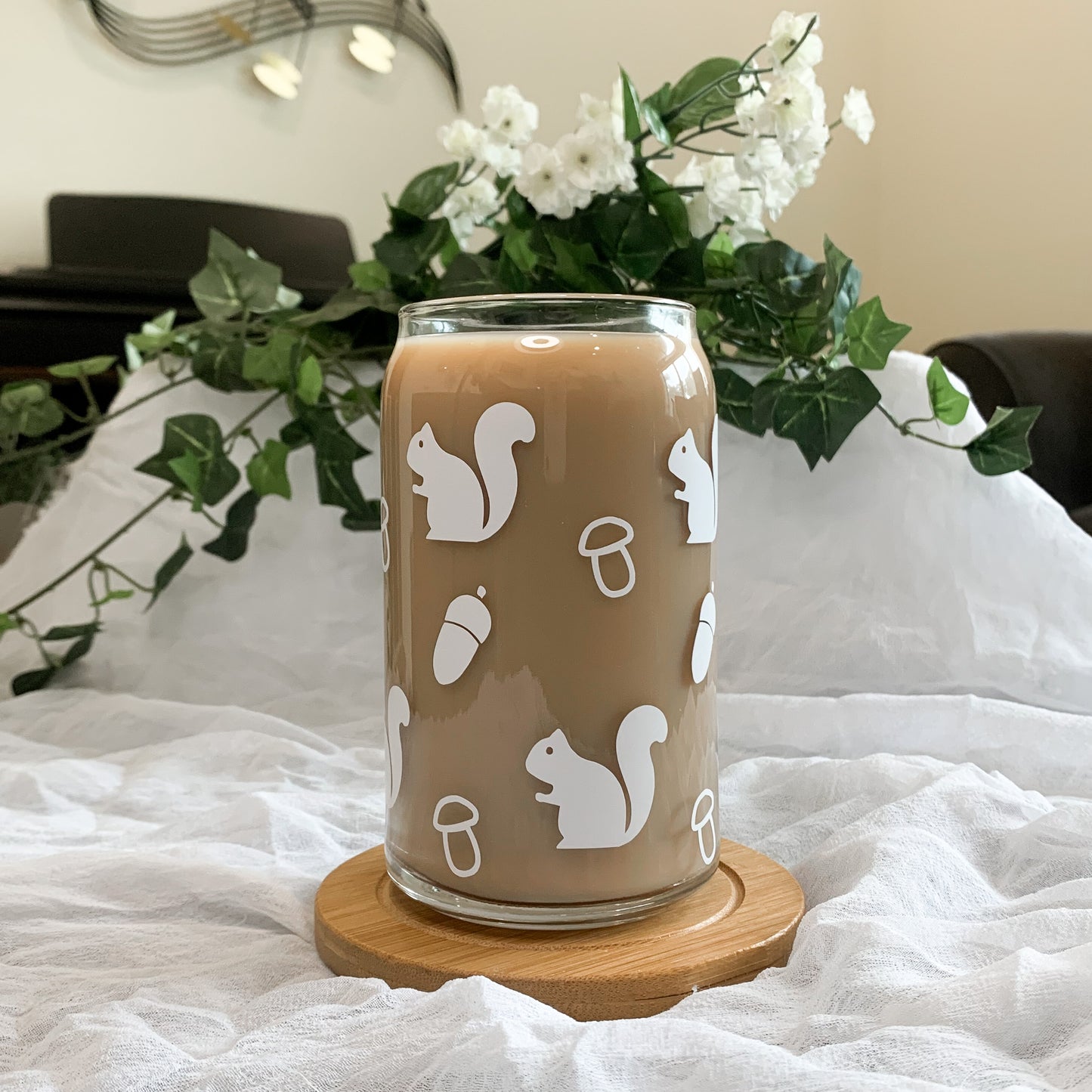 Cute woodland glass cup filled with iced coffee.