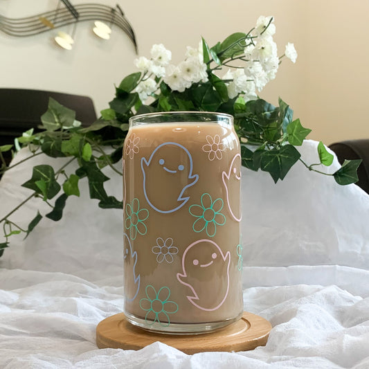Cute pastel ghost cup in front of floral background.