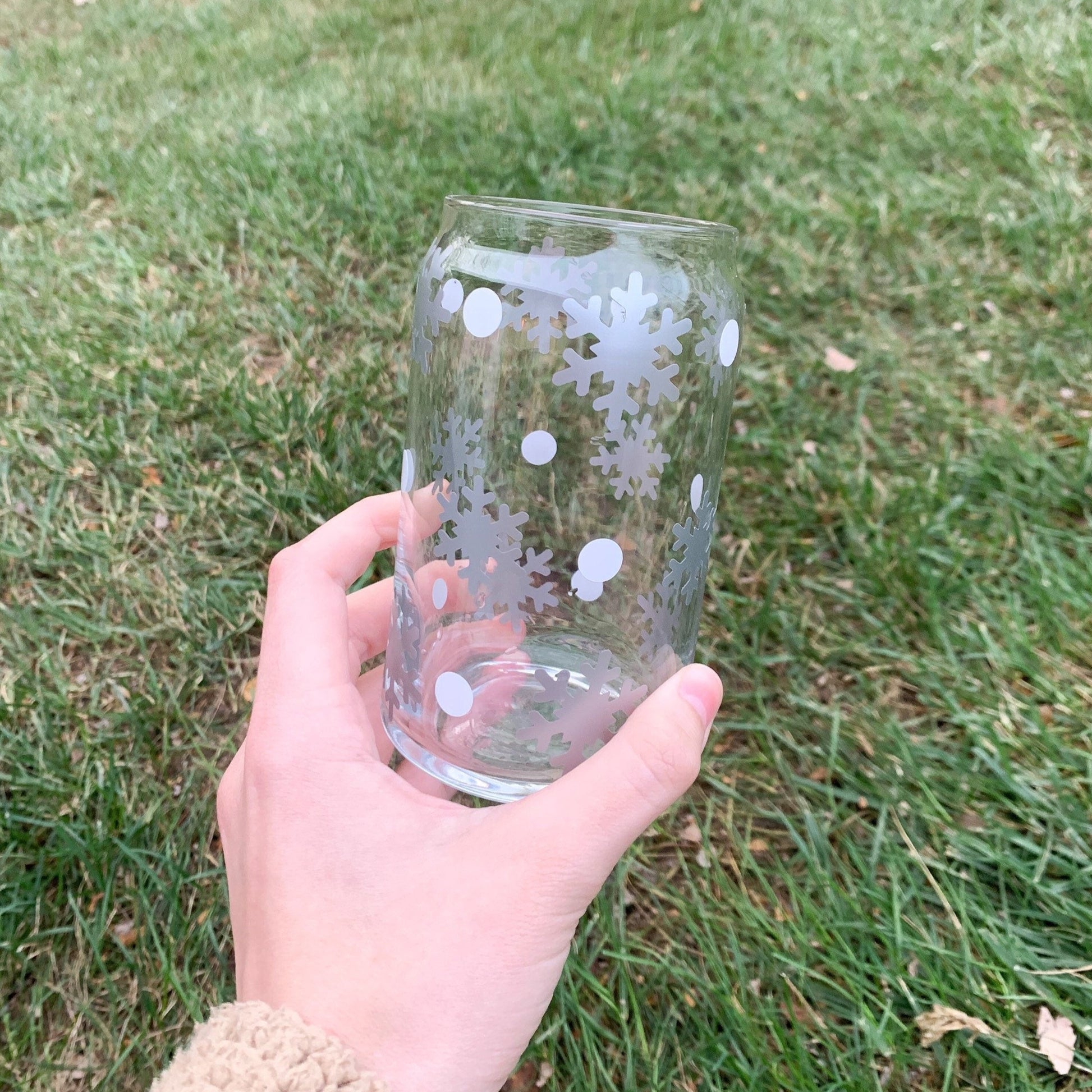 16 ounce winter wonderland cup being held over grass.